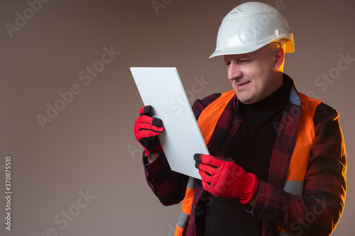 Builder is holding a white ...