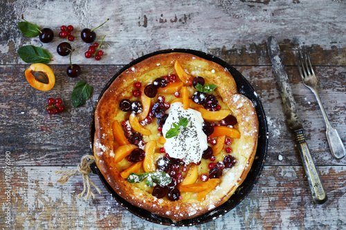 Selective focus. Dutch baby pancake. Healthy homemade dessert. Trend dessert with fruit. photo