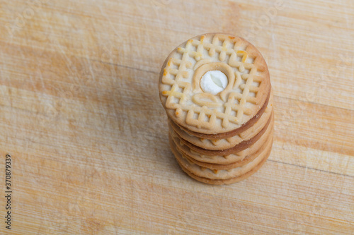 Cream sandwich biscuits on the wooden board 