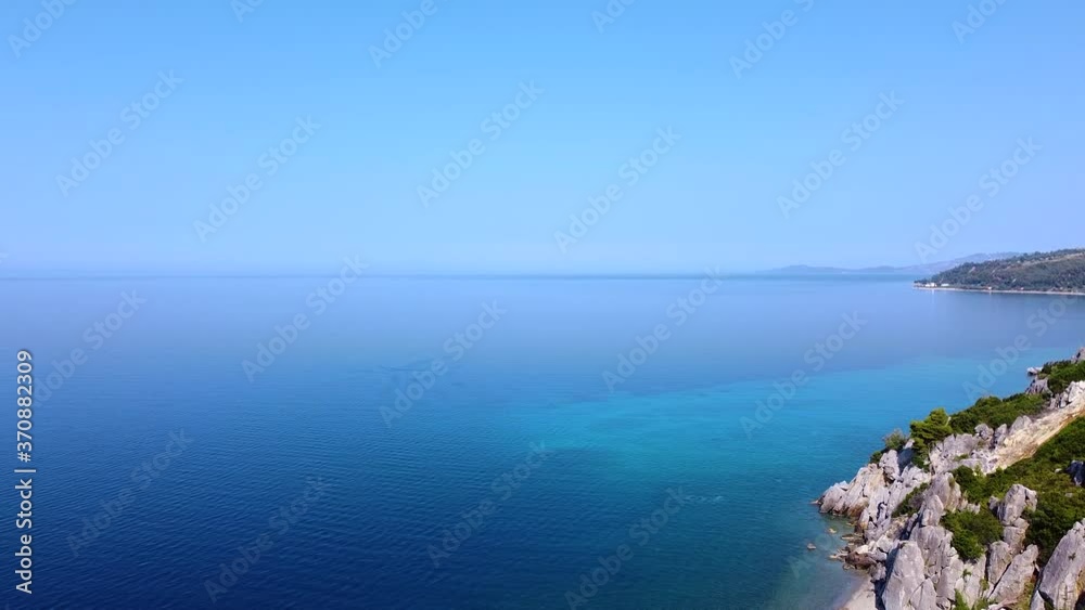 Amazing blue tranquil open sea with rocky coast in summer season. Aerial Amazing blue tranquil open sea with rocky coast in summer season. Aerial