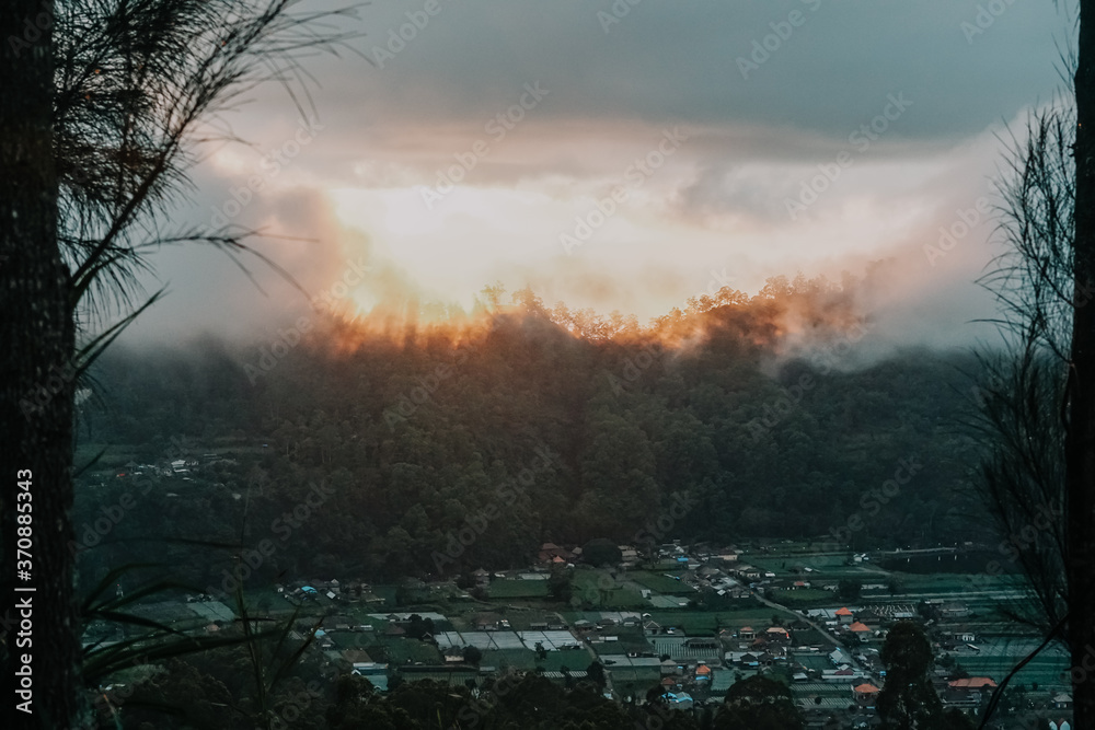 Kintamani is a village on the western edge of the larger caldera wall of the Mount Batur (Gunung Batur) caldera in Bali, Indonesia. It is on the same north–south road as Penelokan and has been used as