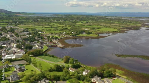 Kinvara, Galway, Ireland, August 2020, Drone flying high while slowly pushing towards fishing village. photo