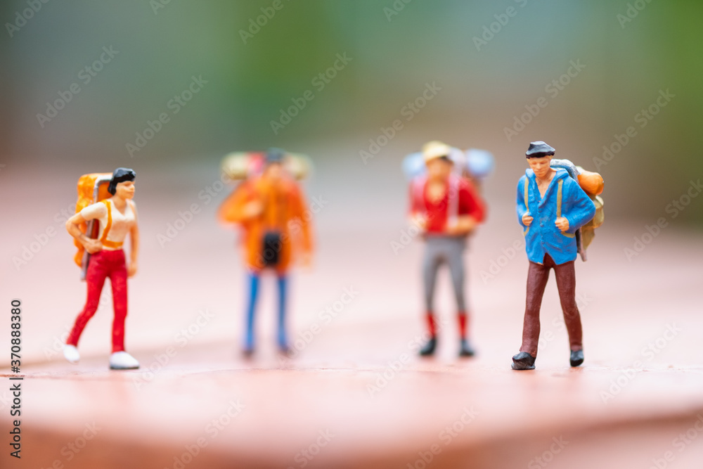 Miniature people: Group of backpacker using as business trip traveler adviser agency or explorer on earth background concept.