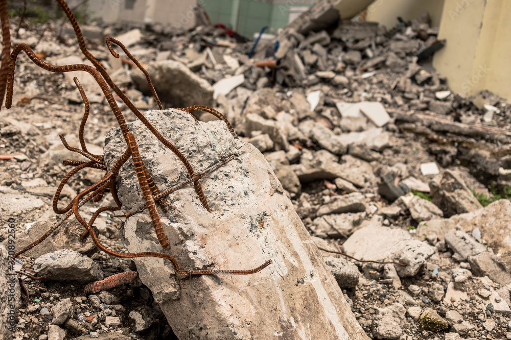 Closeup of a ruined pillar with exposed rebar. Can represent demolition