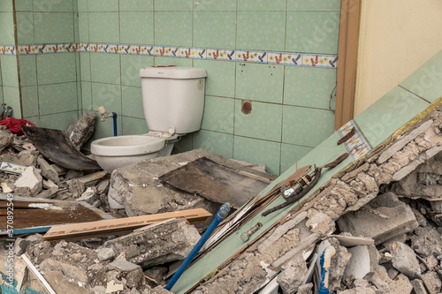 Картината върху платно A demolished bathroom, with one wall and the toilet still intact
