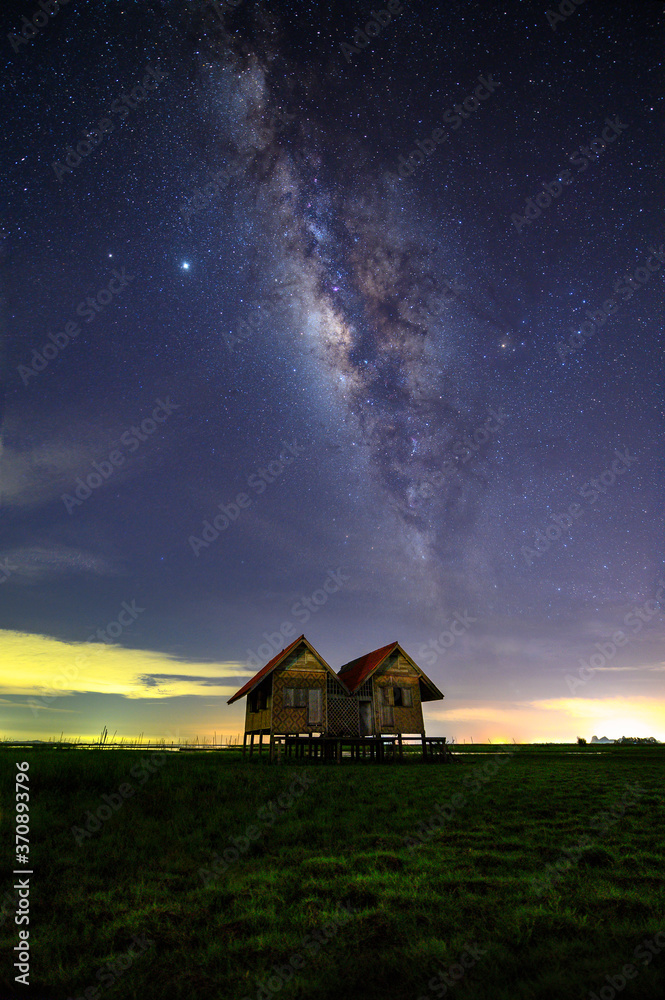 The old twin house near Chaloem Phra Kiat Bridge with milky way at Phatthalung Province, Thailand The old twin house near Chaloem Phra Kiat Bridge with milky way at Phatthalung Province, Thailand