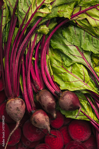 Food background with 4 beet, beetroot, beet slices and leaves.