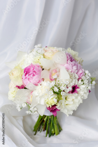 Beautiful wedding bouquet on white fabric background