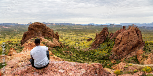 African American Hiker Looking at Arizona Desert from Flatiron Peak Panorama photo