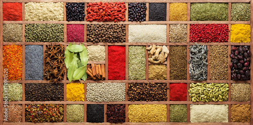 Fototapeta Naklejka Na Ścianę i Meble -  Spices and herbs in  wooden box, top view. Seasonings from all over the world for cooking food.
