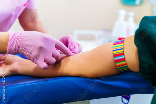 Nurse's hands taking a blood on isolated over laboratory room background.