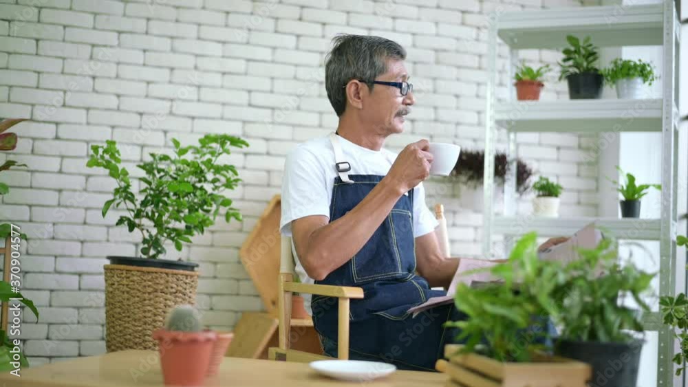 An elderly man is relaxing with coffee and reading Newspaper at his home . An elderly man is relaxing with coffee and reading Newspaper at his home .