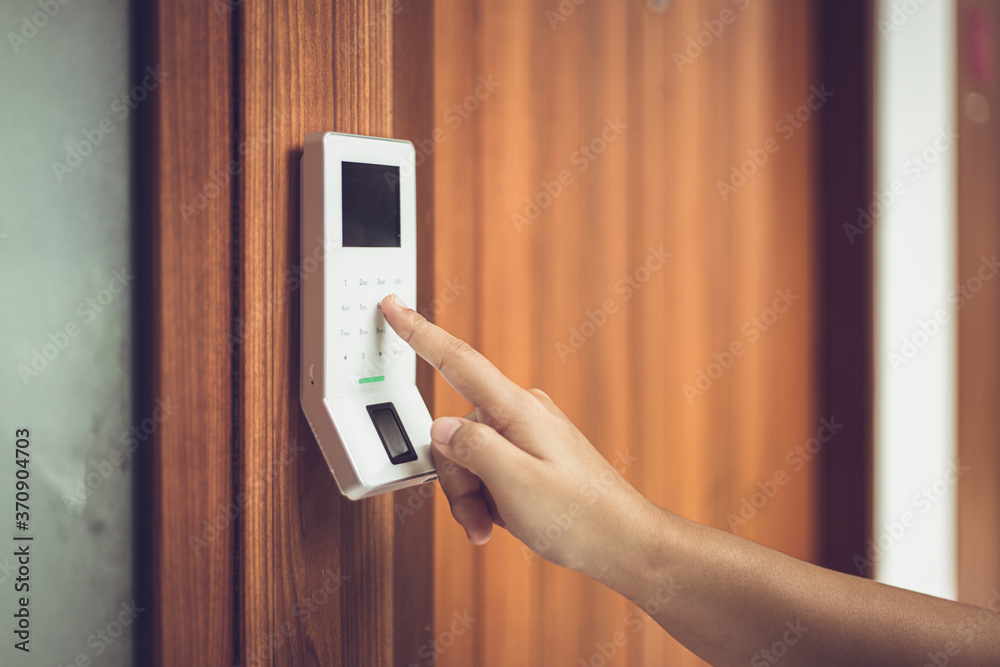 hand typing password at electronic door lock and security system panel. hand typing password at electronic door lock and security system panel.