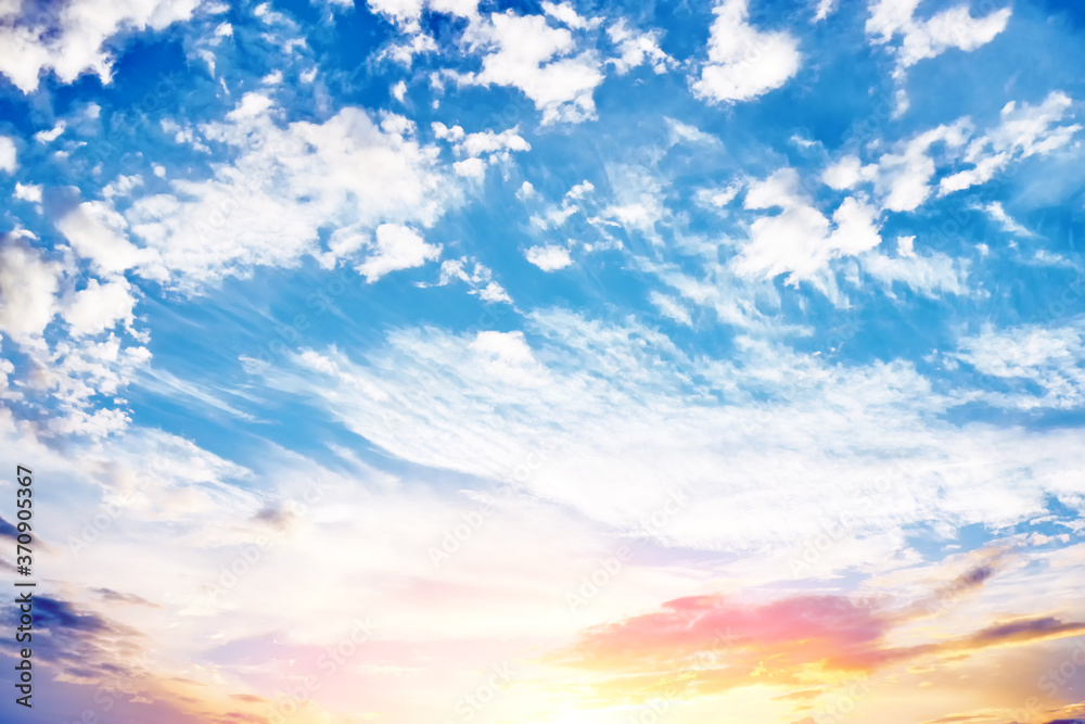 Obraz premium cold sunset sky landscape background with sun below horizon. Wide view of clouds skyline on evening. Natural blue red yellow orange color of cloudscape