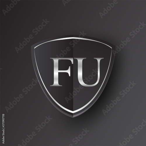 Initial logo letter FU with shield Icon silver color isolated on black background, logotype design for company identity.
