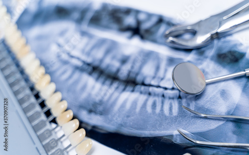 Dental pan x-ray, denture and dental instruments. Artificial jaw on white background.