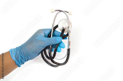 Hand in medical latex gloves holding stethoscope. Isolated on white.
 photo