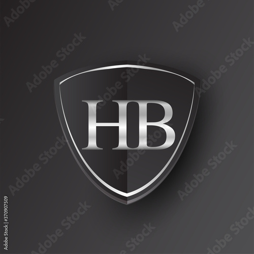 Initial logo letter HB with shield Icon silver color isolated on black background, logotype design for company identity.