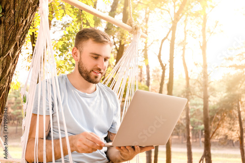 Young man with laptop relax...