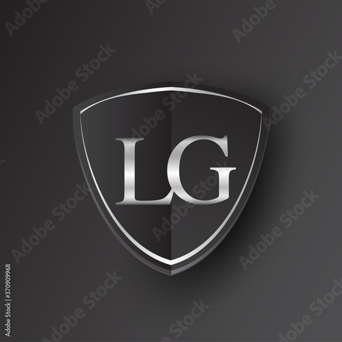 Initial logo letter LG with shield Icon silver color isolated on black background, logotype design for company identity.