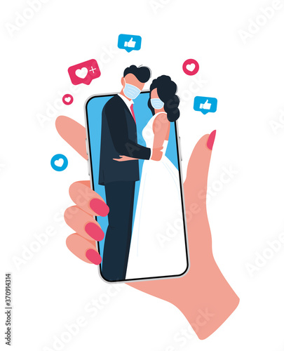 Online wedding ceremony with smartphone. Newlyweds wearing face masks. New normal.