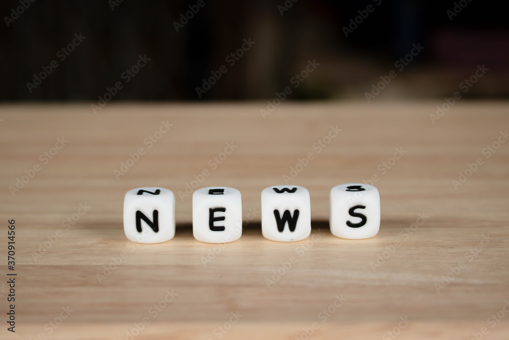 Wooden dice depicting the letters NEWS word concept