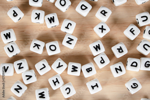 Text dice cube concept / Letter dices alphabet on wooden background. Block of alphabet studded on the floor.