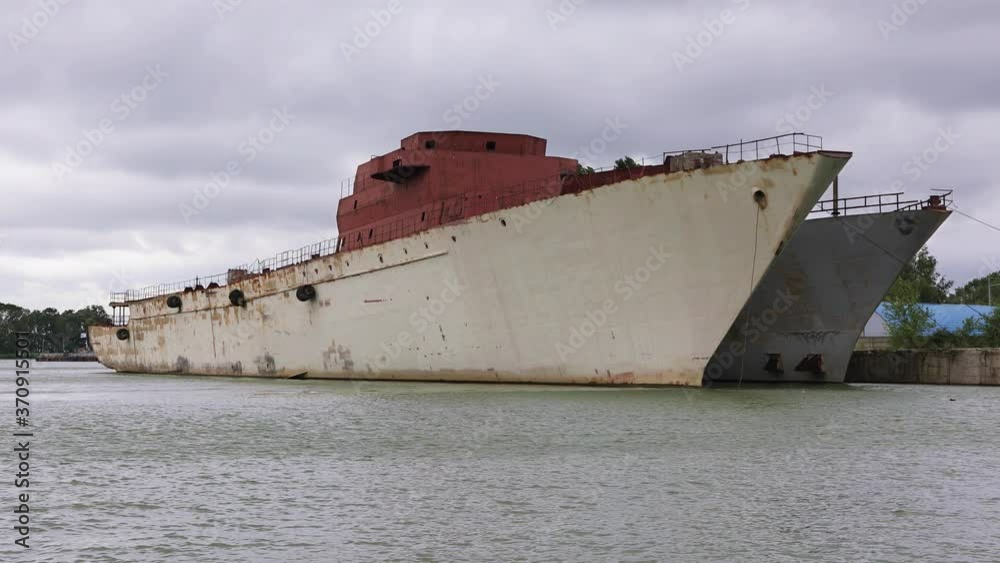 Two old warships are moored on the riverbed against a dramatic sky. Waiting to be sawed and disposed of
Two old warships are moored on the riverbed against a dramatic sky. Waiting to be sawed and disposed of