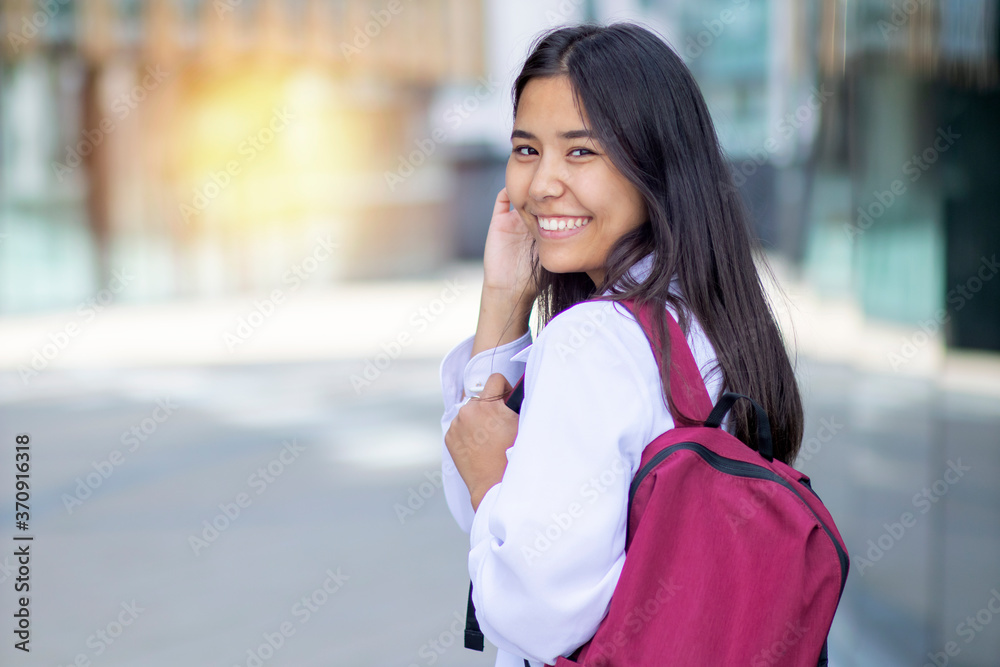 Happy smiling Asian woman, female student goes to study Happy smiling Asian woman, female student goes to study