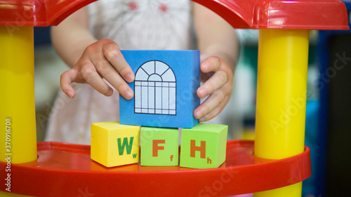 Wallpaper Mural Little asian girl enjoying while playing with creative toy blocks at home. Torontodigital.ca