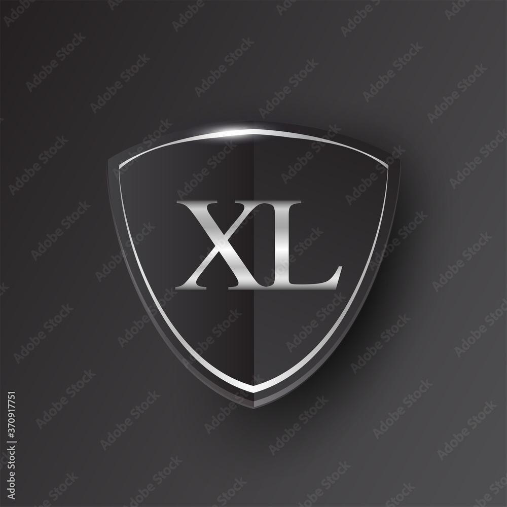 Initial logo letter XL with shield Icon silver color isolated on black ...