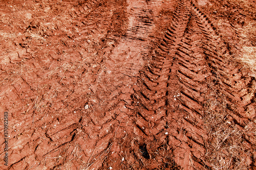 Traces of a truck on red soil.