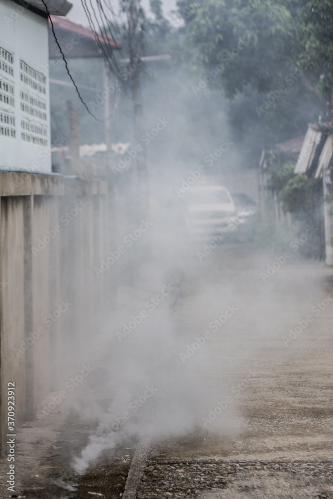 Officers enter the area to spray fog to prevent dengue fever.