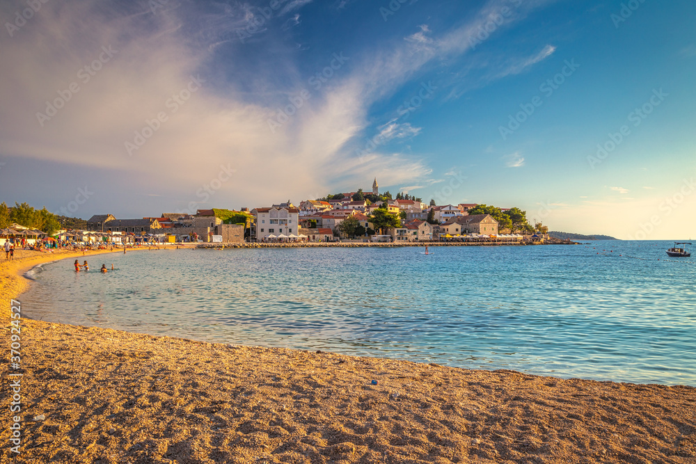 Beach at sunset near Primosten town, a popular tourist destination on the Dalmatian coast of Adriatic sea in Croatia, Europe.
