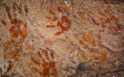 Ochre Hands, Red, Orange, Yellow hand prints on rock, Aboriginal art in Queensland, Australia.