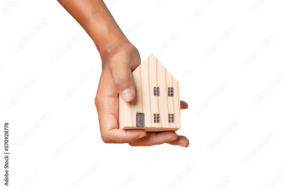 hand holding wooden model house isolated on white background. clipping path. hand holding wooden model house isolated on white background. clipping path.