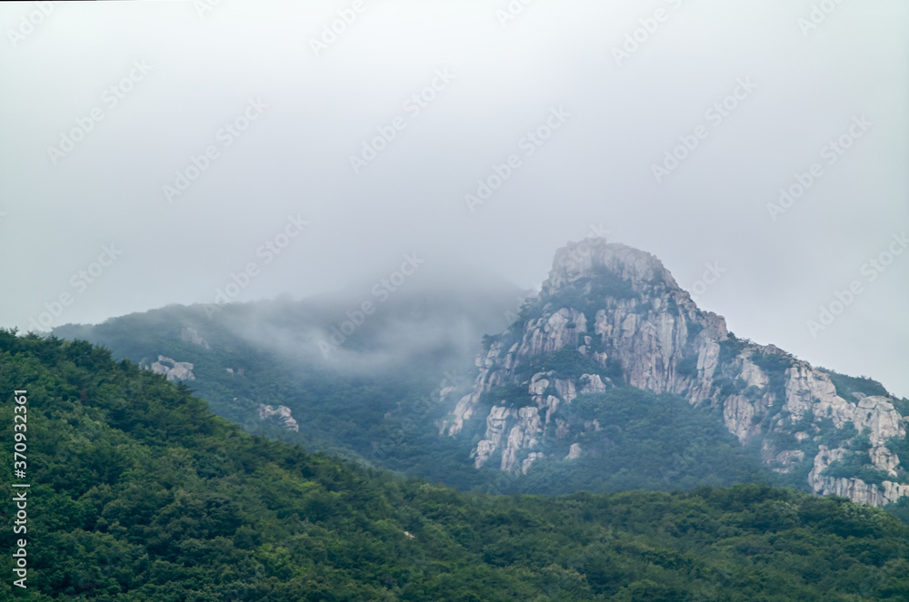 The cliff on peak of Geumjeongsan Mountain and the weather just before heavy rain in Busan, South Korea The cliff on peak of Geumjeongsan Mountain and the weather just before heavy rain in Busan, South Korea
