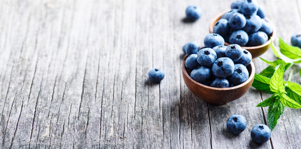 Bowl of fresh blueberries on blue rustic wooden table closeup. Bowl of fresh blueberries on blue rustic wooden table closeup.