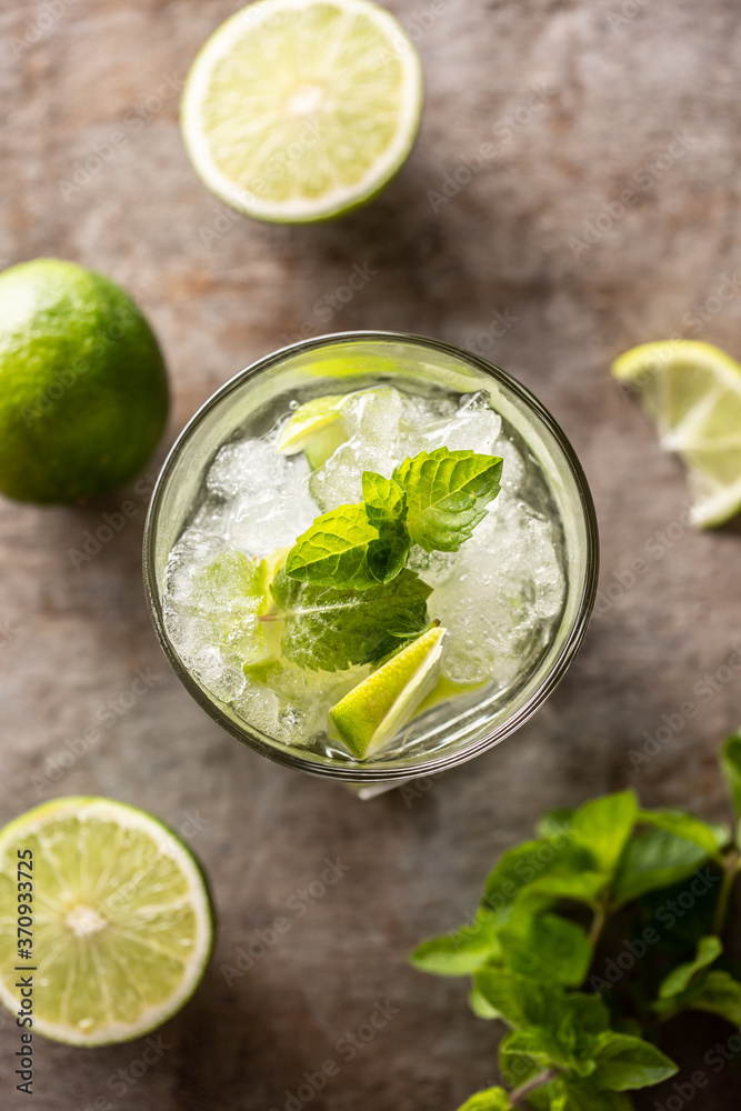 Mojito cocktail drink with white rum lime mint herbs and soda on the bar counter. Mojito cocktail drink with white rum lime mint herbs and soda on the bar counter.