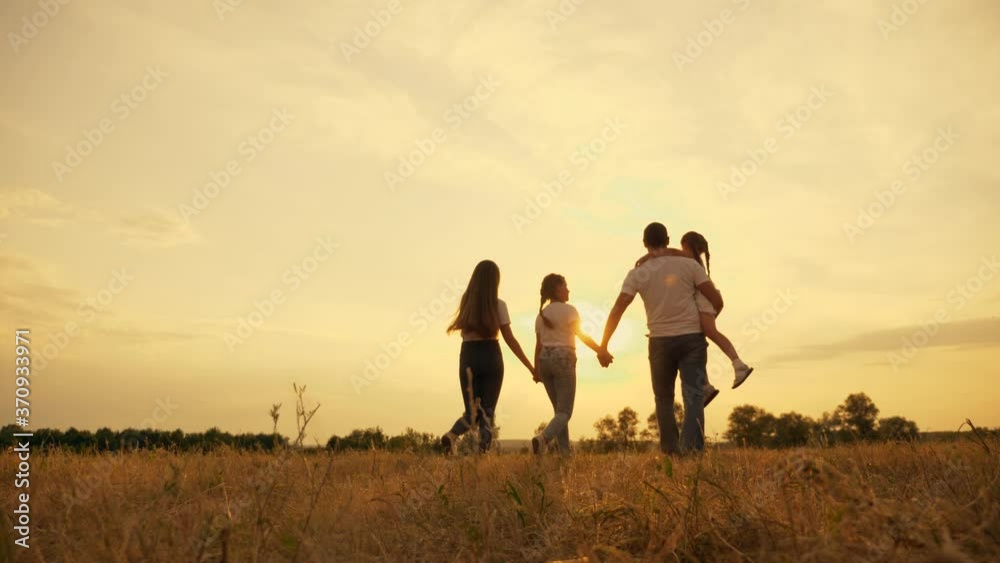 Happy friendly family with children on a walk in the Park. Happy funny kids are walking with their mom and dad. Large family. The father holds the child in his hand. Happy friendly family with children on a walk in the Park. Happy funny kids are walking with their mom and dad. Large family. The father holds the child in his hand.