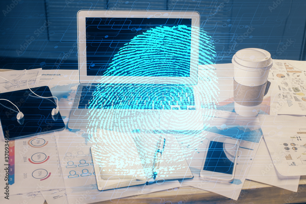 Computer on desktop in office with finger print drawing. Double exposure. Concept of business data security. Computer on desktop in office with finger print drawing. Double exposure. Concept of business data security.