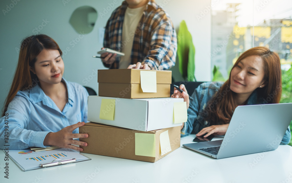 A group of young entrepreneur checking orders from customer for online shopping and delivery concept A group of young entrepreneur checking orders from customer for online shopping and delivery concept