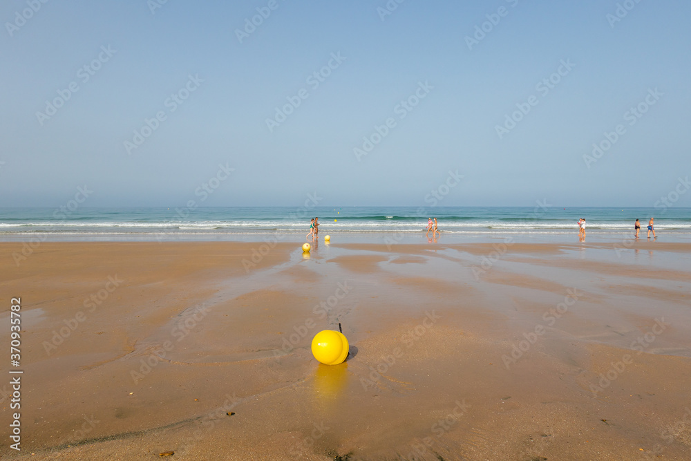 La Barrosa beach in Sancti Petri, Cádiz, with a large amount of sand without water as the tide is low La Barrosa beach in Sancti Petri, Cádiz, with a large amount of sand without water as the tide is low