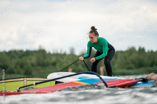 Woman learning winsurfing on the Markkleeberger Lake near Leipzig