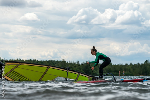 Woman learning winsurfing on the Markkleeberger Lake near Leipzig