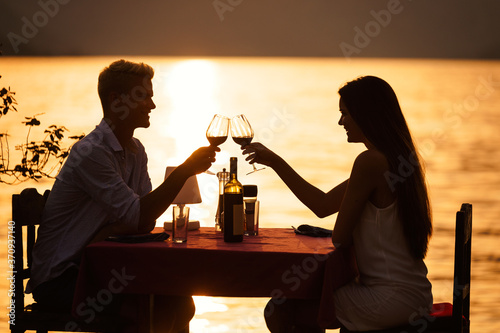 Young couple have romantic evening on sea beach