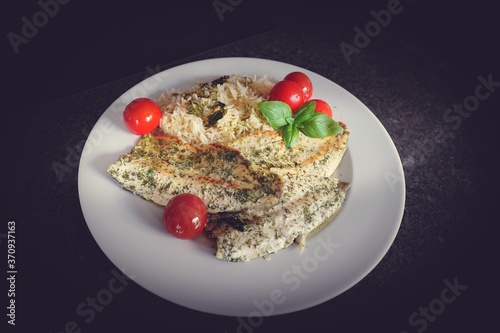 ready to eat -a roasted trout with rice and cherry tomatoes in olive oil