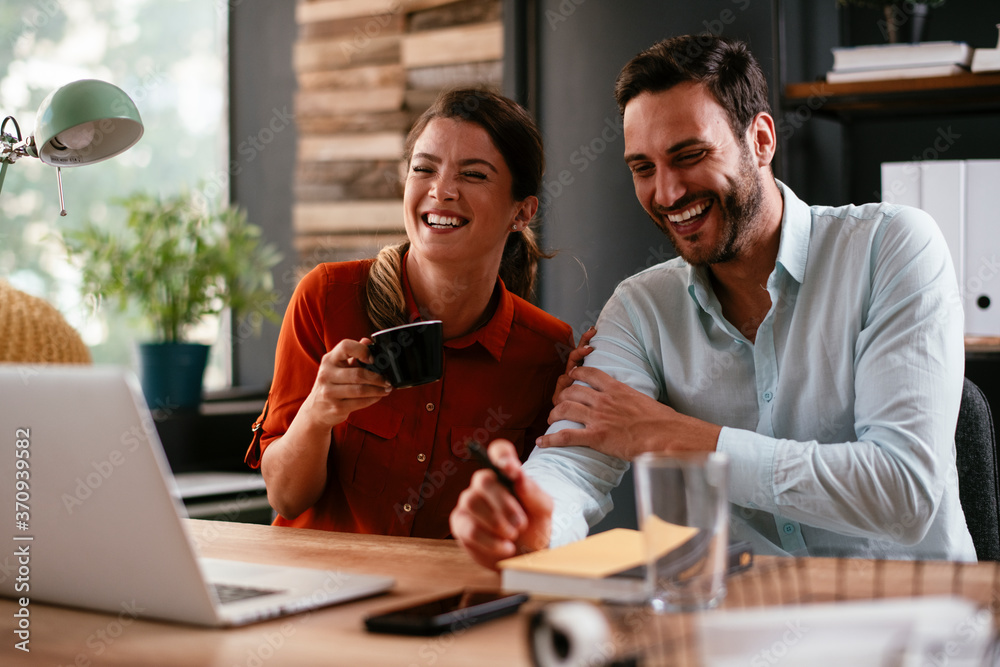 Colleagues in office. Businesswoman and businessman discussing work in office. Two friends in working together. Colleagues in office. Businesswoman and businessman discussing work in office. Two friends in working together.