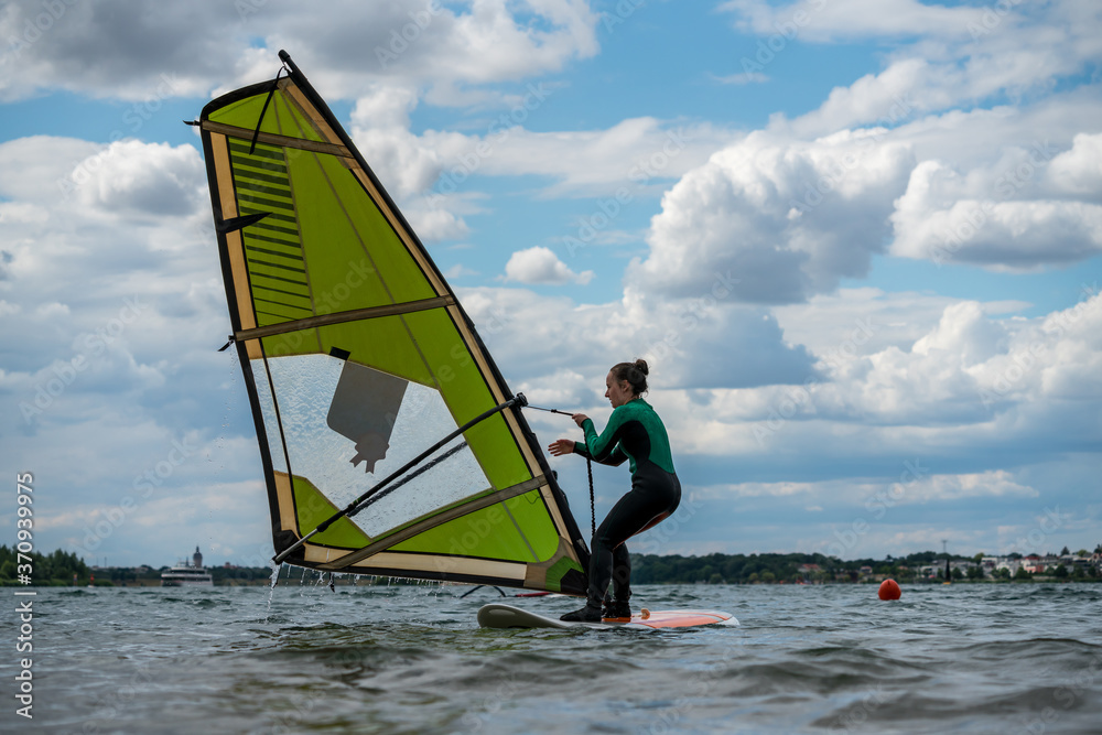 Naklejka premium Woman participating in a windsurfing course