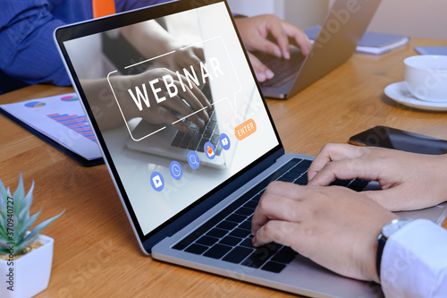 Person using a laptop computer for online training webinar. E-learning browsing connection and cloud online technology webcast concept. Laptop mockup with clipping path on screen.